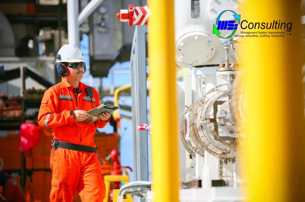 Operator K3 migas memeriksa peralatan kerja untuk memastikan standar keselamatan di industri minyak dan gas